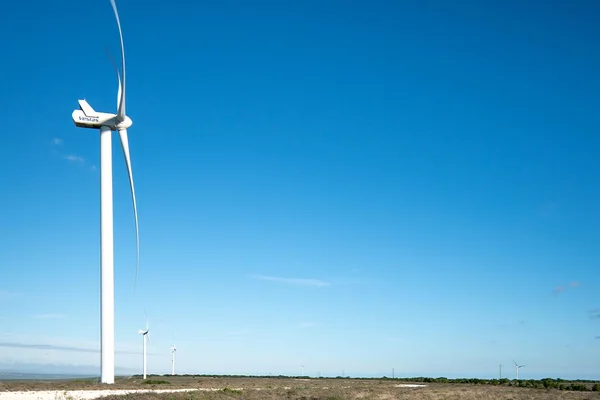 Wind turbine beneath a blue sky